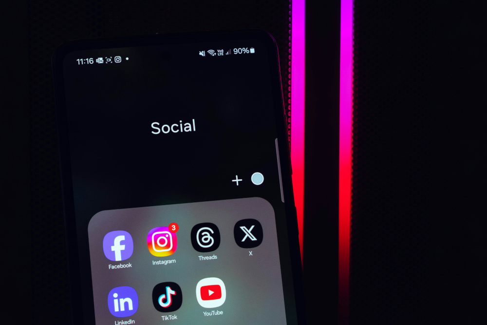the social folder of a smartphone containing facebook, instagram, threads, X, linkedin, tiktok, and youtube